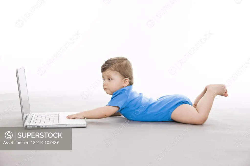 Baby on floor with laptop
