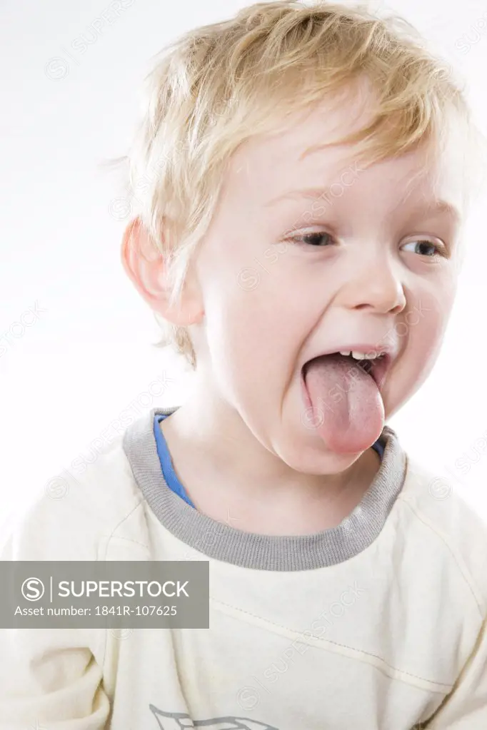 toddler boy poke out tongue