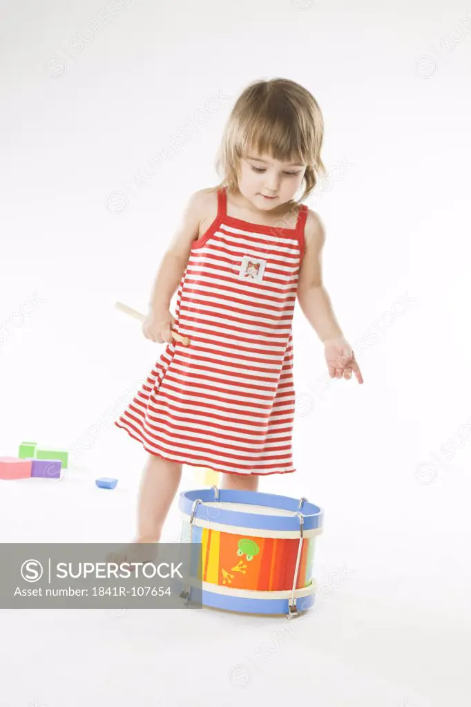 baby playing on drum