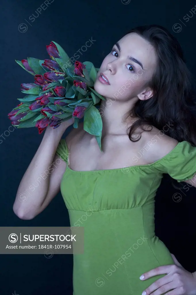 young woman with banch of tulips