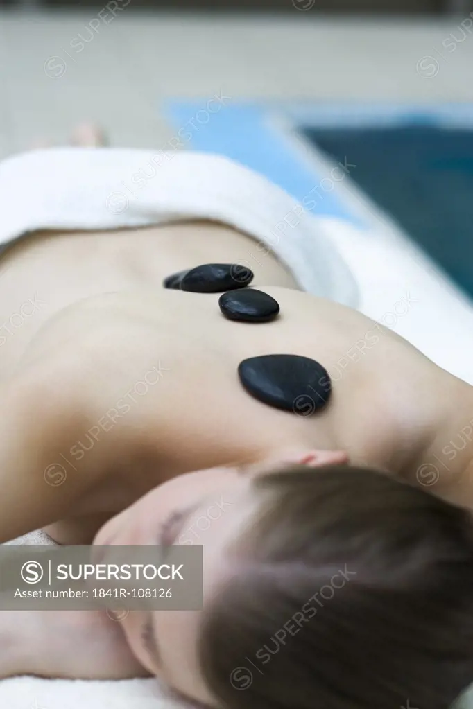 Woman receiving stones massage