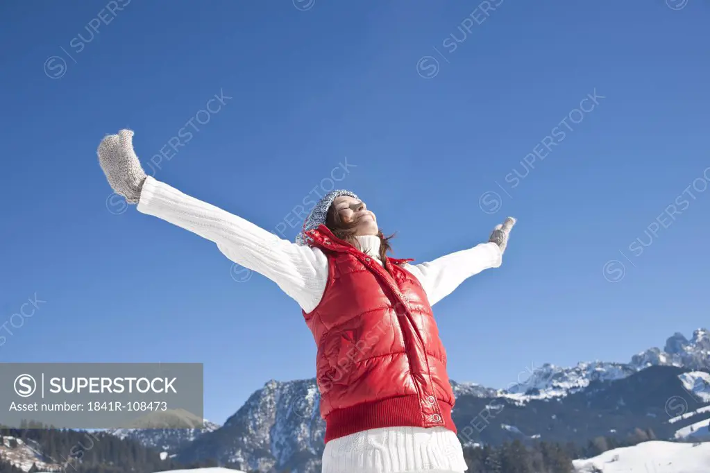 Happy woman in winter landscape, Tannheimer Tal, Tyrol, Austria