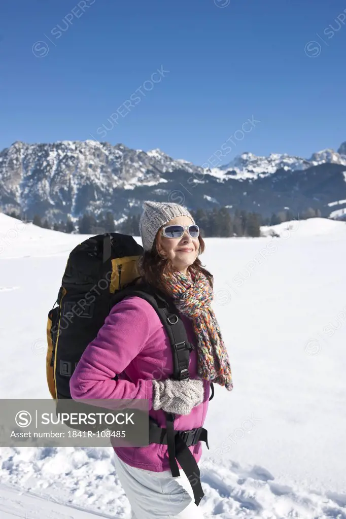 Woman hiking in snow, Tannheimer Tal, Tyrol, Austria