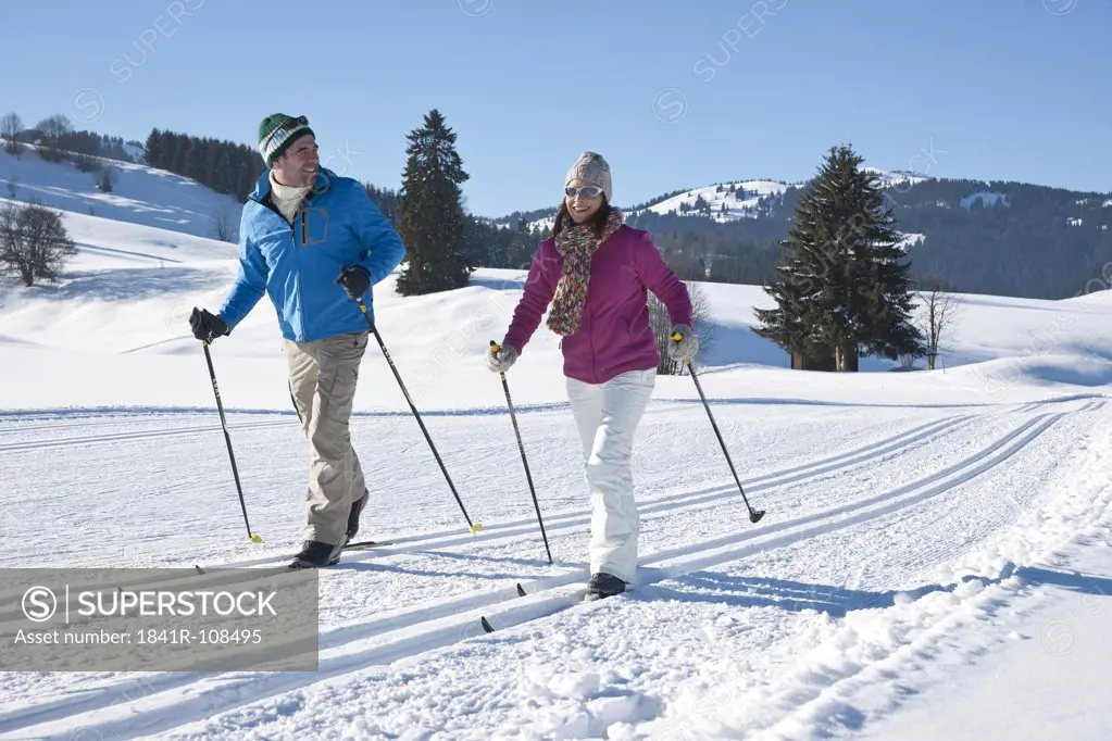 Couple cross-country skiing, Tannheimer Tal, Tyrol, Austria