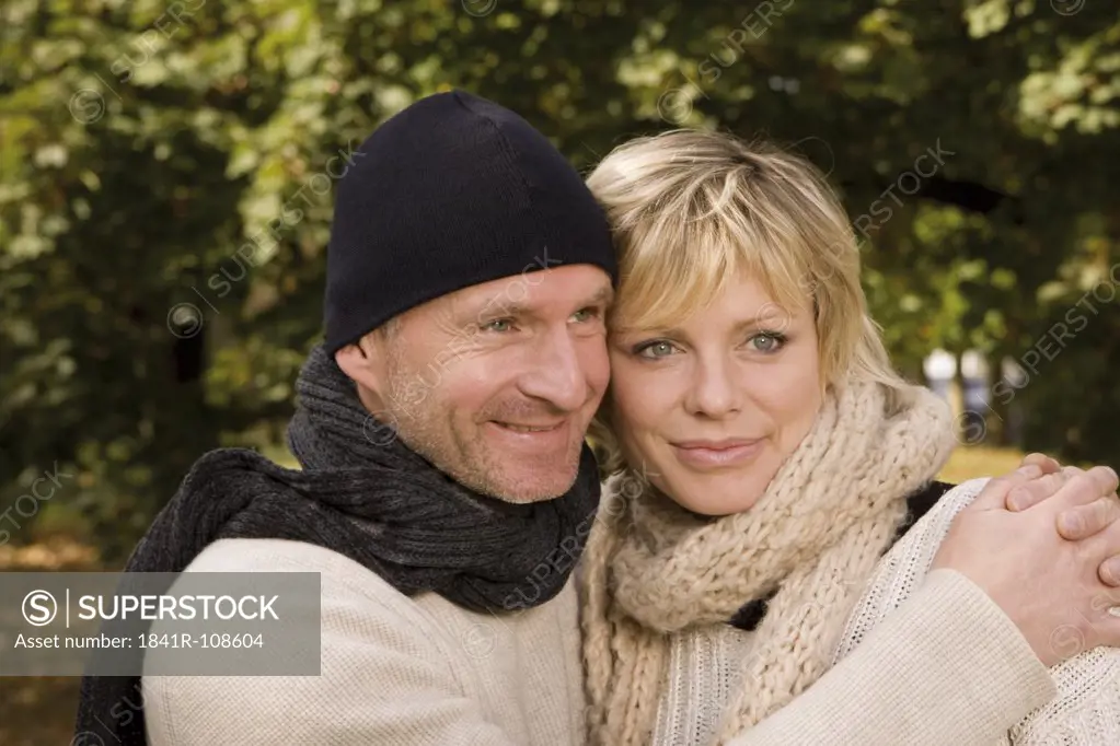 Happy couple embracing outdoors