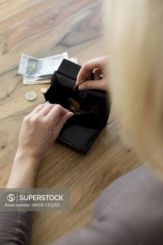 Woman counting money from wallet