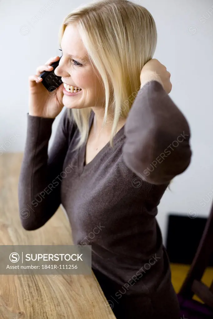 Happy blond woman on the phone