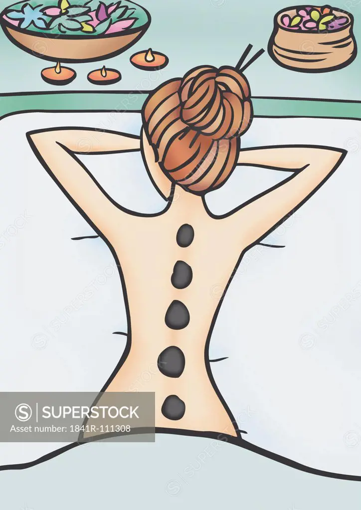 Woman with hot stones on her back