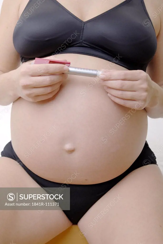 Pregnant woman wearing underwear with insulinpen