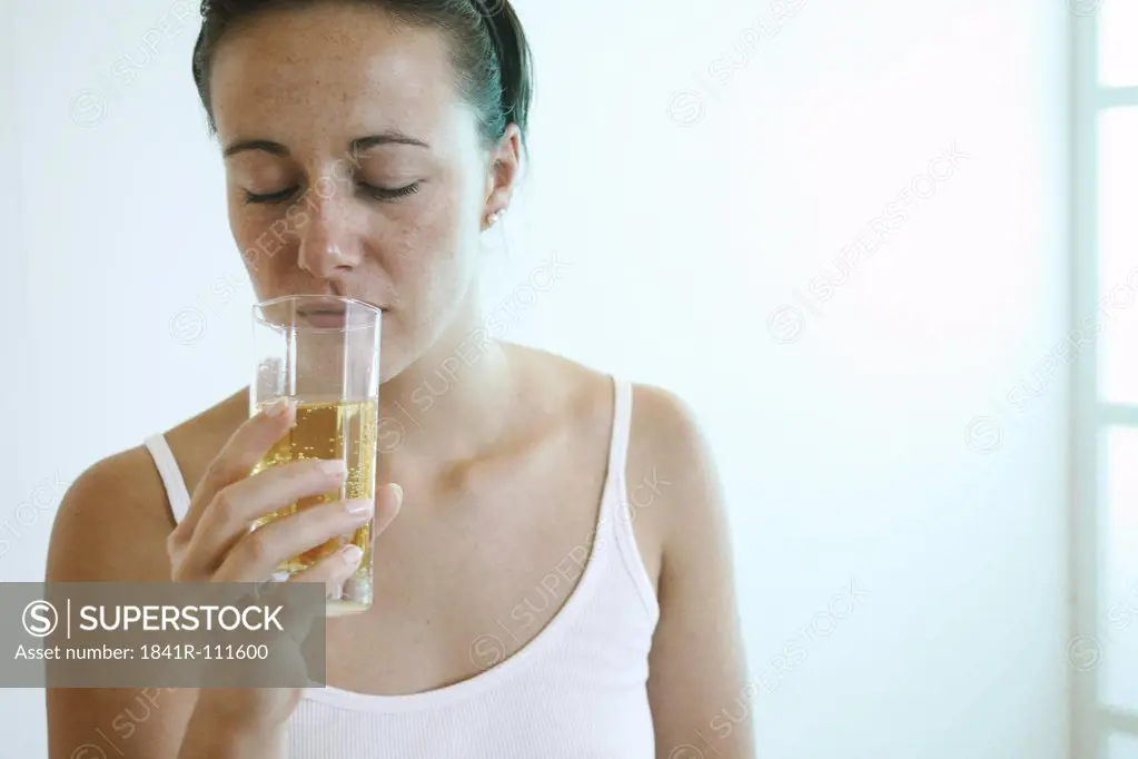 Young woman is drinking juice.