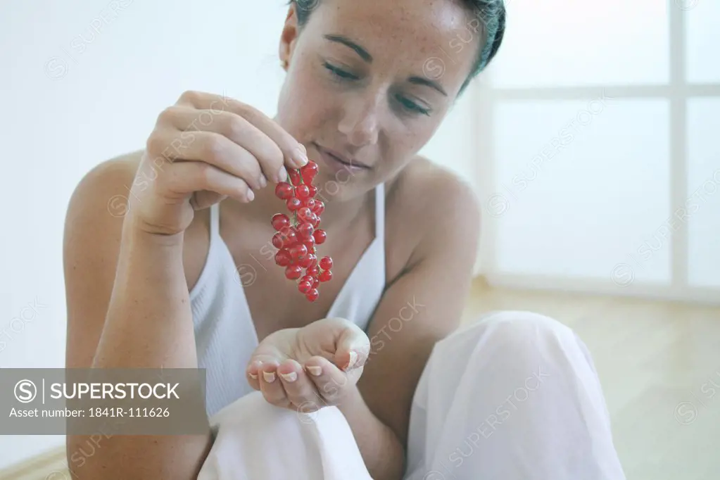 Young woman holding berries.