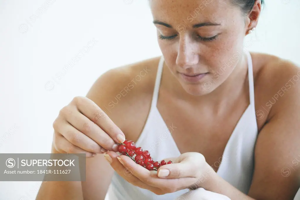 Young woman holding berries.