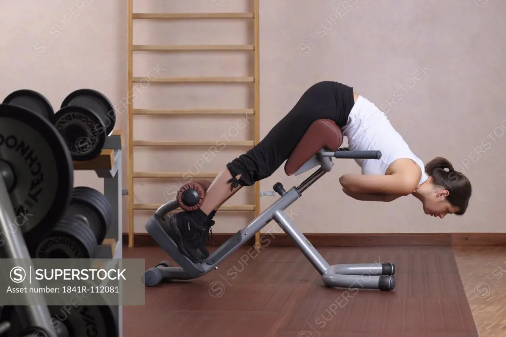young woman training at a gym machine