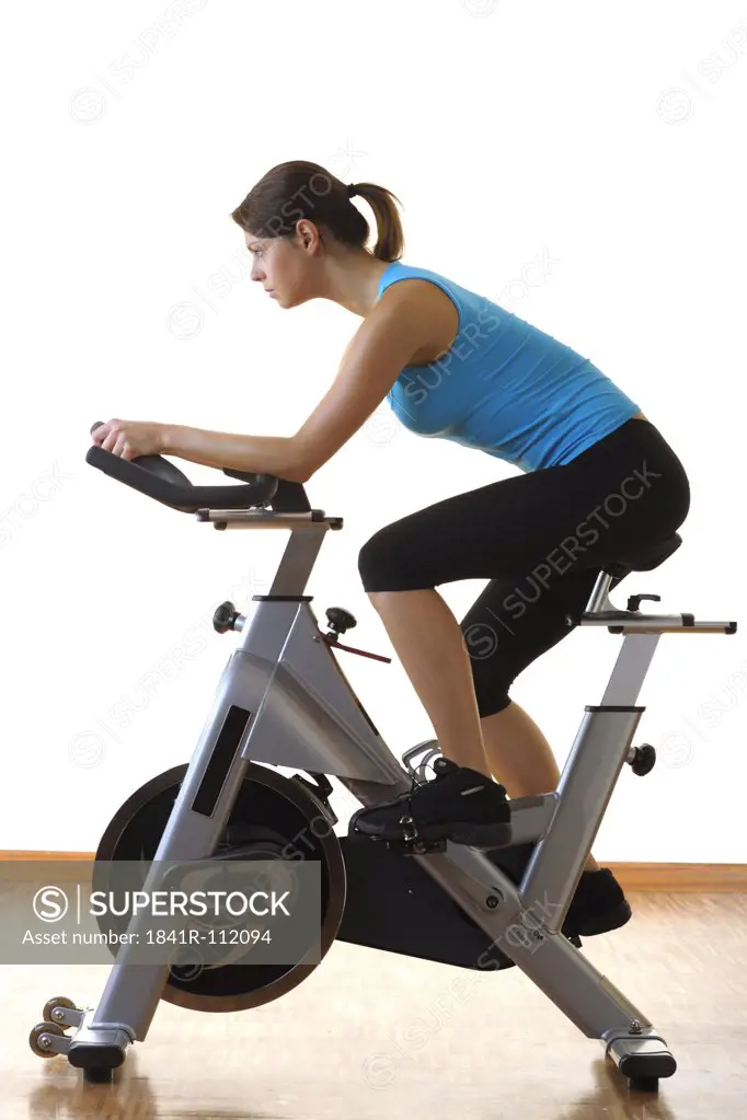 young woman at an ergometer in a fitness center