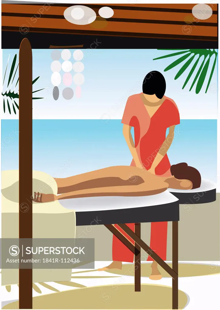 young woman getting massage by female therapist - next to the sea