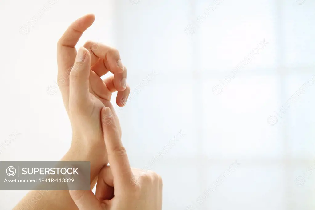 two well-groomed hands in front of white background