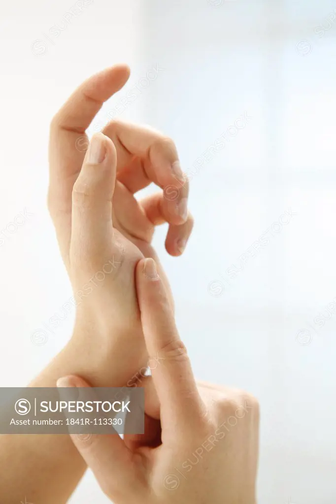 two well-groomed hands in front of white background