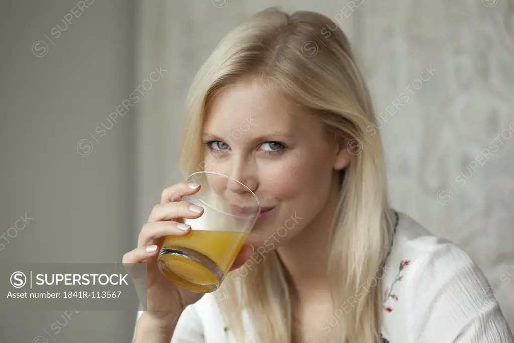 Young woman drinking juice