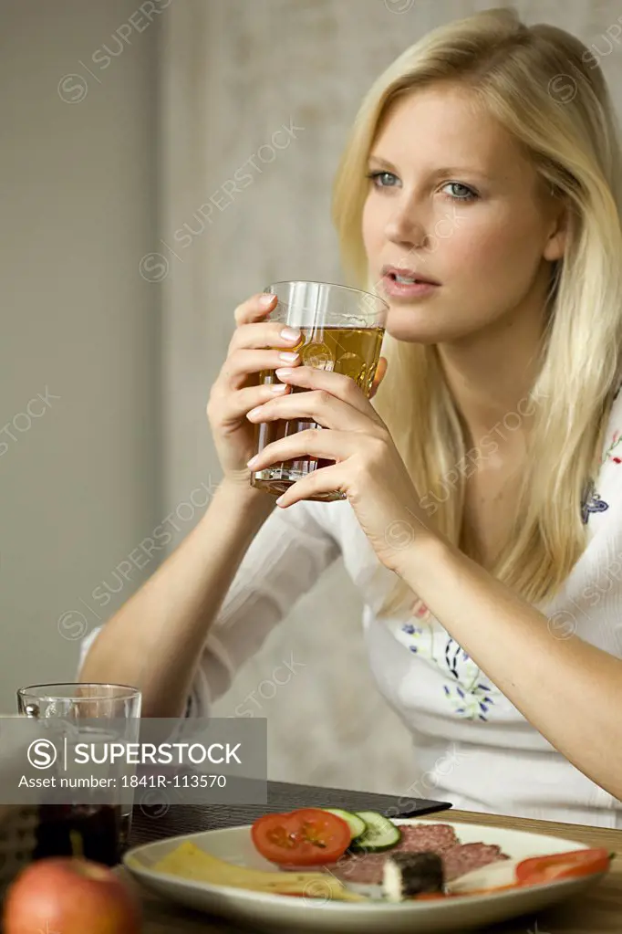 Young woman with tea glass
