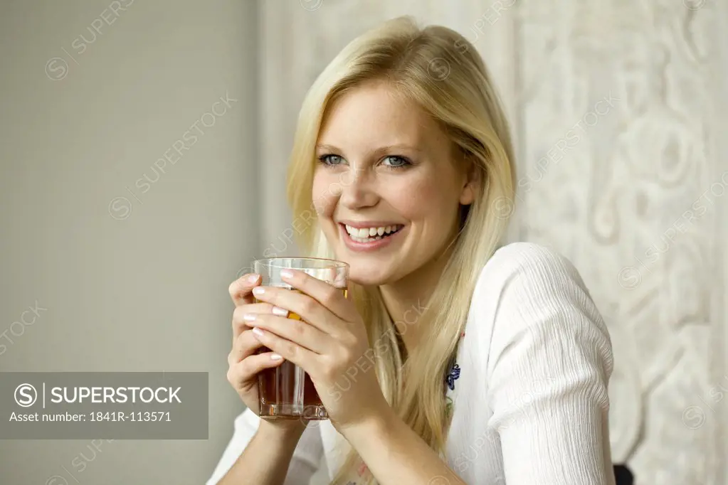 Young woman with tea glass