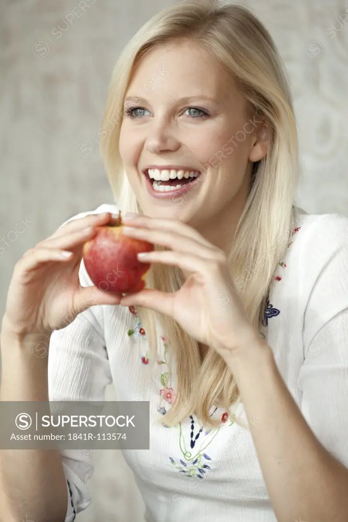 Blond woman with an apple