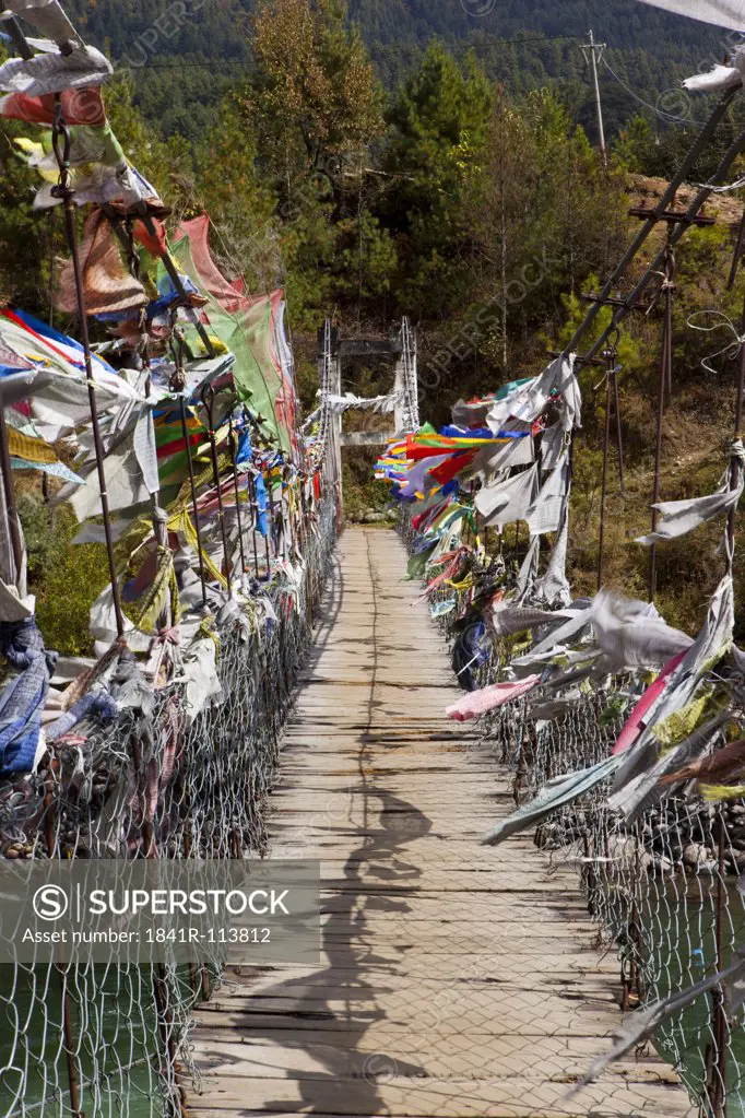 Swing bridge with prayer flags in Kurjey, Bhutan