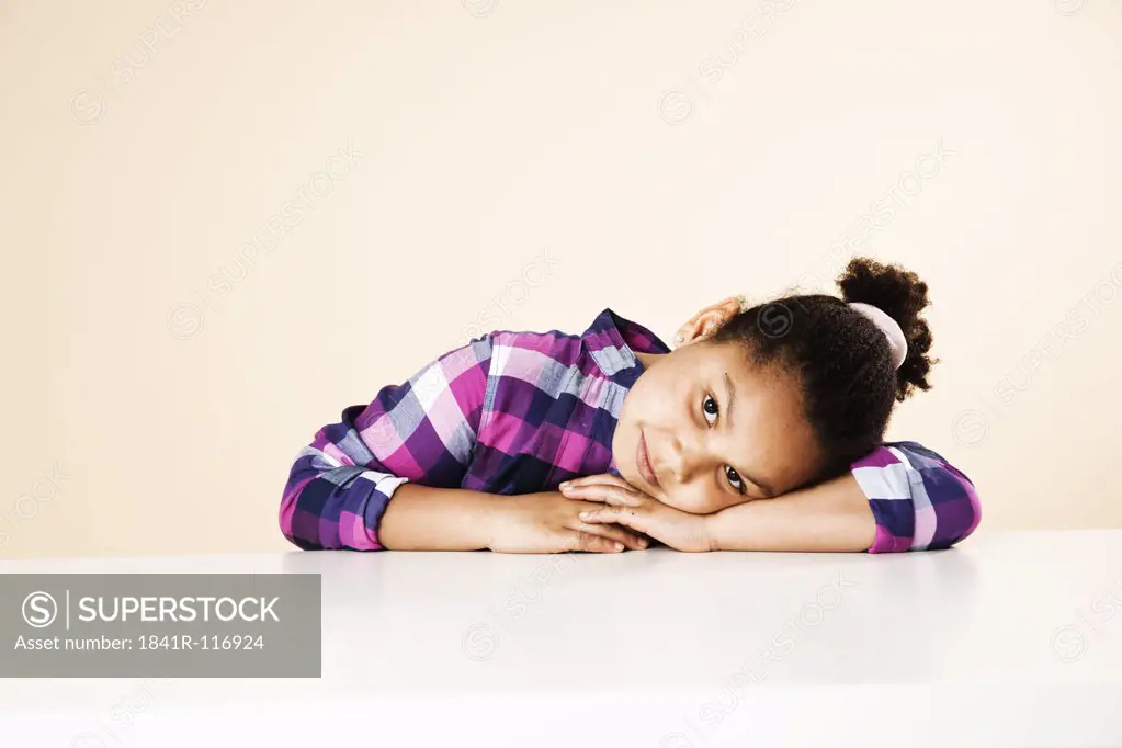 Girl resting her head on table