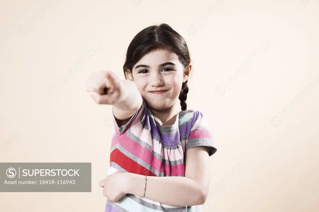Grinning girl pointing her finger