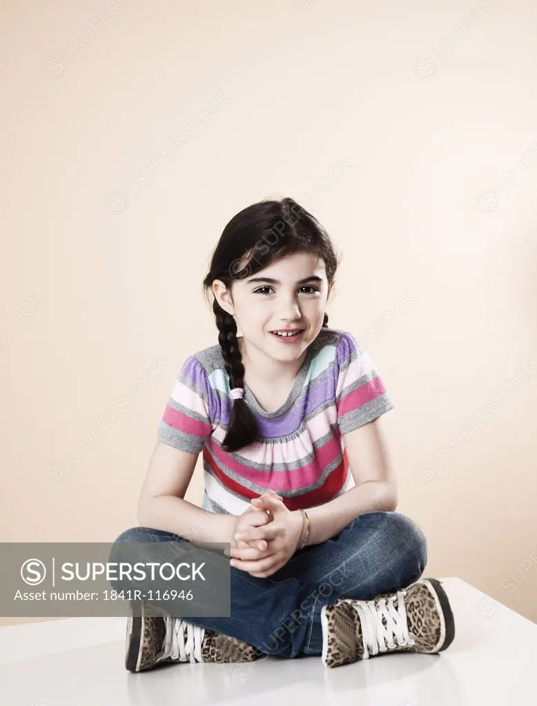 Smiling girl sitting on table
