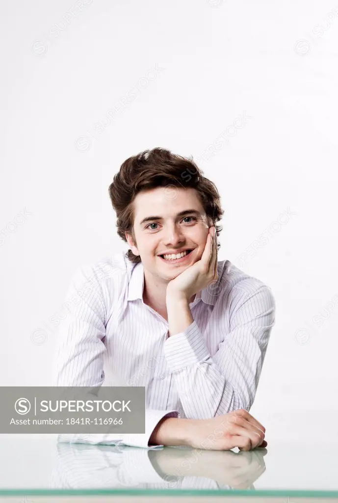 Smiling young man at desk
