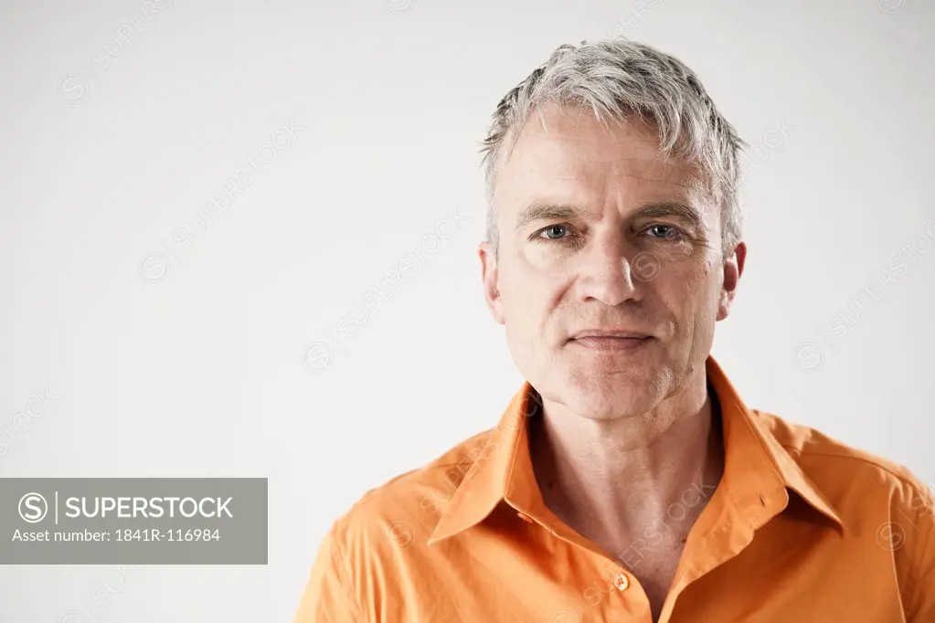 Confident mature man wearing orange shirt