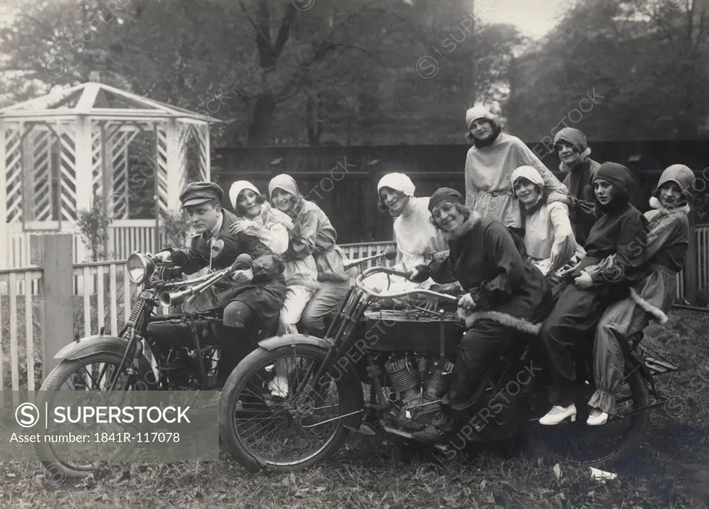 Historical picture of young people sitting on Motorbikes
