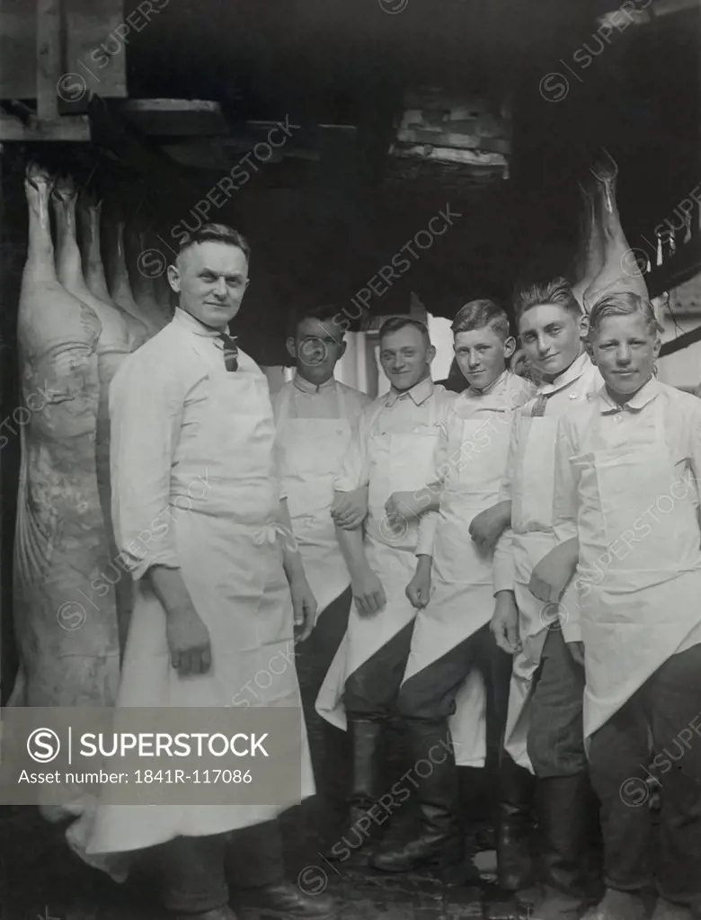 Historical picture of men in a butchery