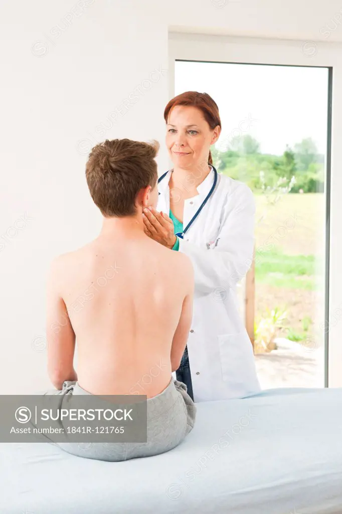 Male teenage boy at female doctor