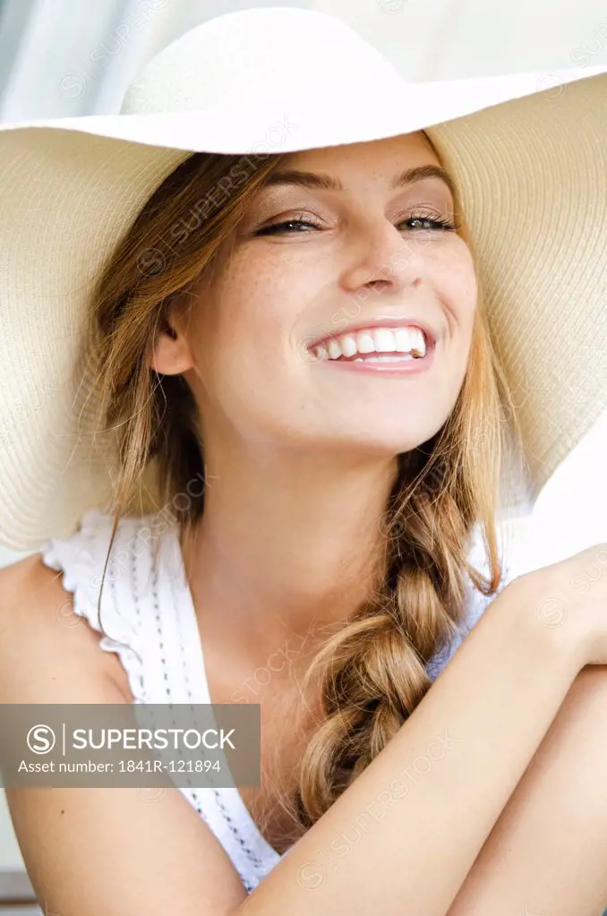 Smiling young woman wearing sunhat, portrait