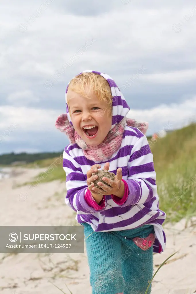 Happy girl playing on the beach