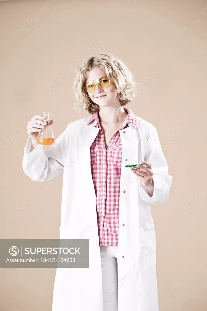 Teenage girl with petri dish and lab coat