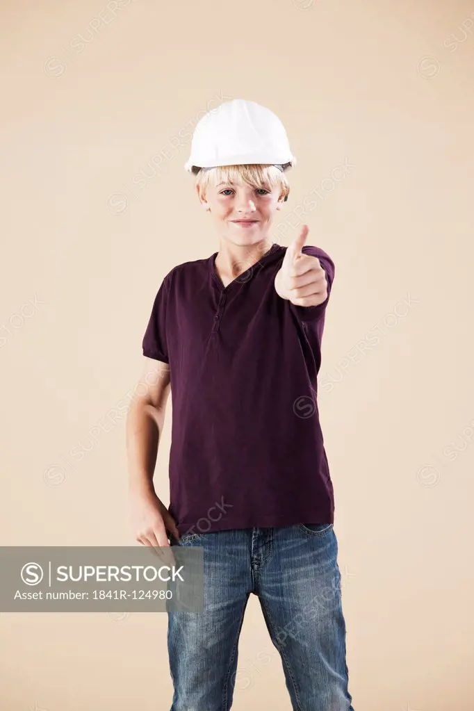 Boy with hard helm and thumbs up