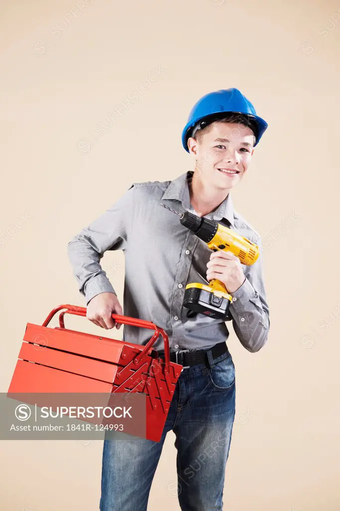 Teenage boy with hard helm and tool box