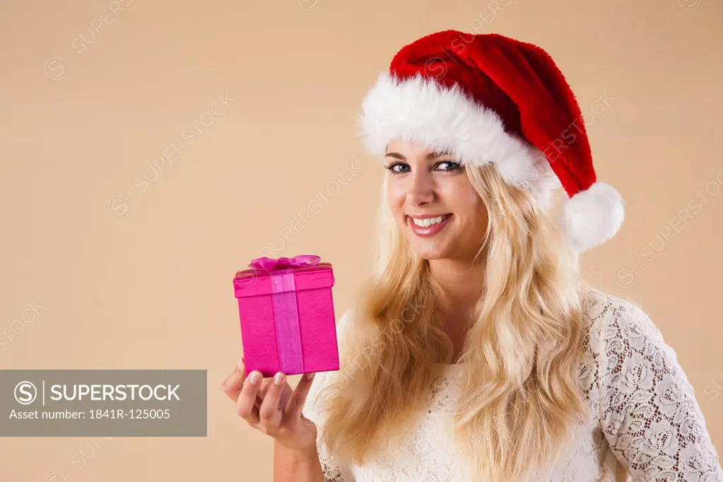 Young woman with santa's hat and present