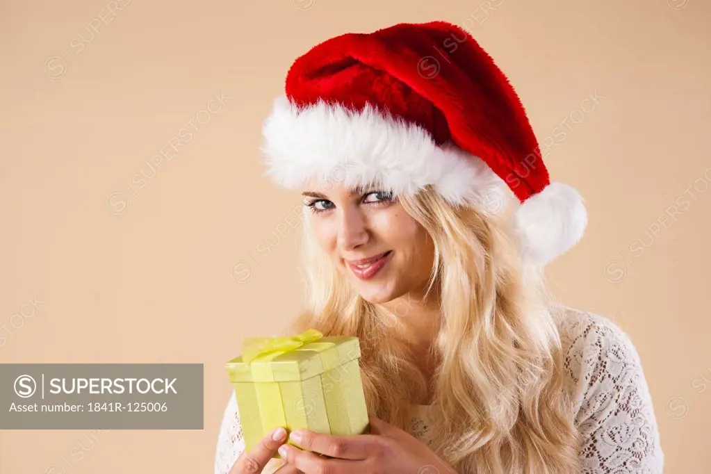 Young woman with santa's hat and present