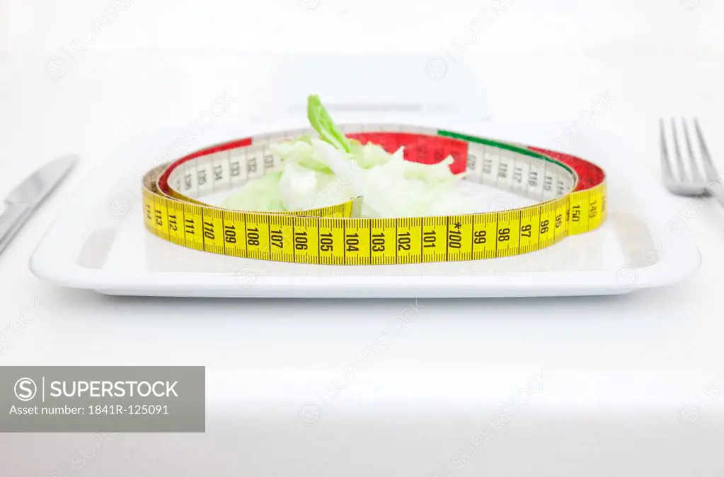 Plate with salad and tape measure