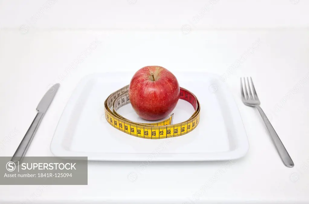 Plate with apple and tape measure
