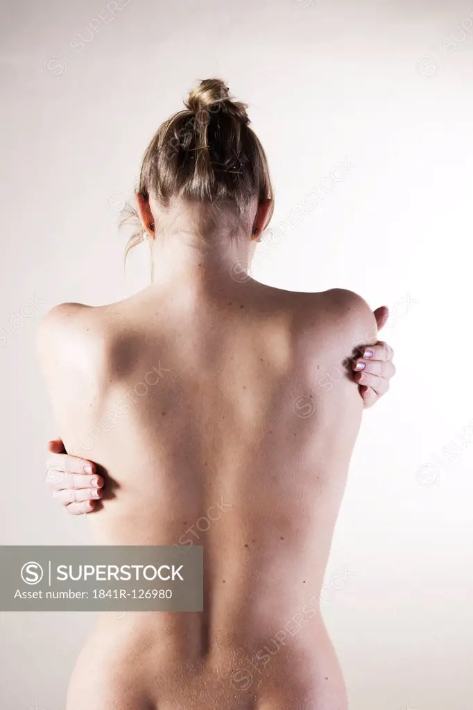 Young woman with pain in the back