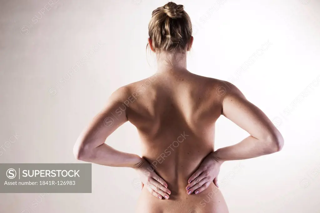 Young woman with pain in the back