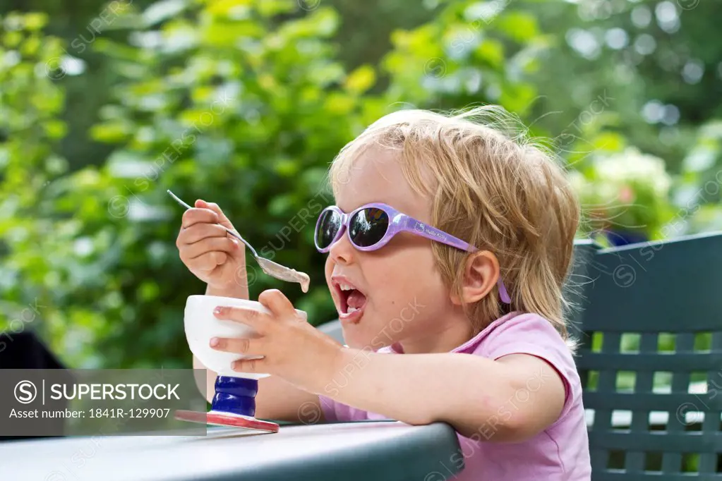 Girl eating ice cream bowl