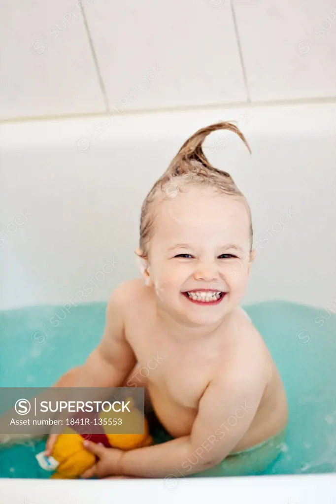 Happy little girl in bath