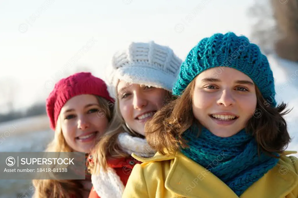 Teenage girls smiling in warm clothing