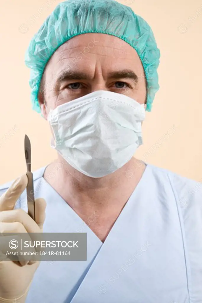 Male surgeon holding scalpel