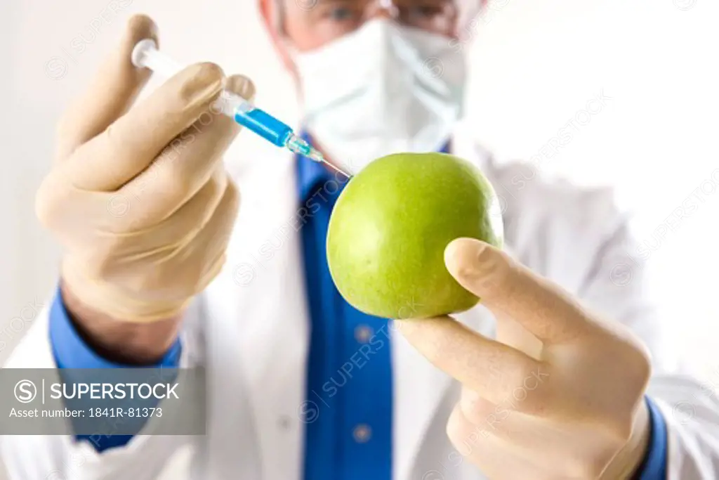 Scientist injecting granny smith apple